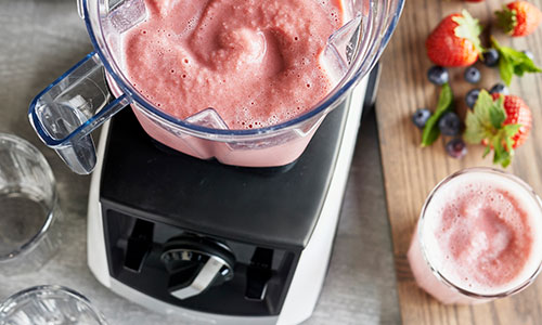 blender with strawberry smoothie