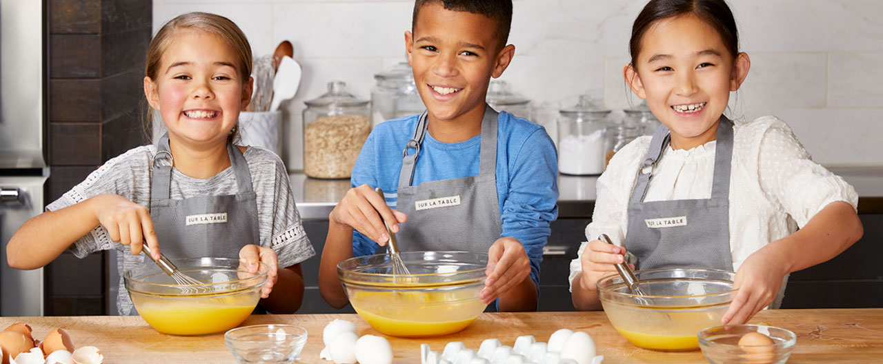 Learn More about Kids and Teens cooking classes kids cooking together in the kitchen