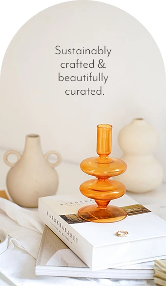 Sustainably crafted and beautifully curated. Vase on top of stacked books.