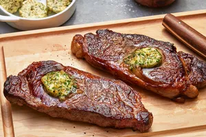 New York steaks with herb butter