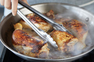 Chicken searing in skillet
