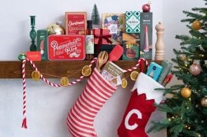 Christmas stockings hanging on the mantle with stocking stuffer gifts