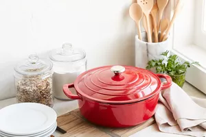 Sur La Table Cast Iron Round Wide Covered Dutch Oven in red, 7 Qt