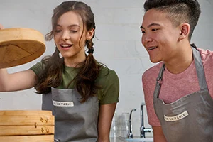 teen boy and girl cooking in Sur La Table kitchen