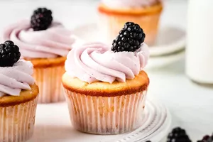 frosted cupcakes with blackberries