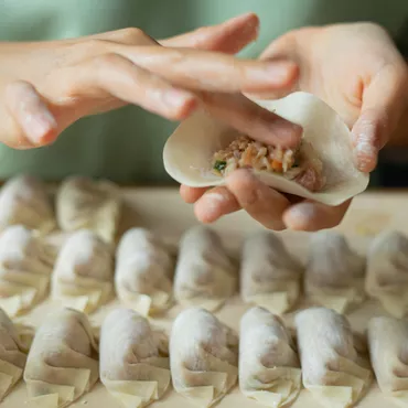 Dumpling Wrapper Dough being filled by hand