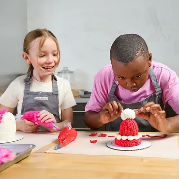 girl and boy making Cozy Cap Cake