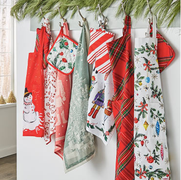 Christmas towels and aprons hanging on pegs