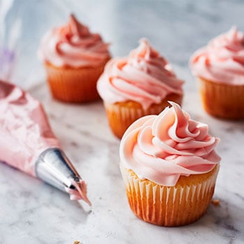 white cupcakes with pink frosting