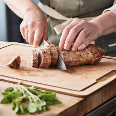 Chefs slicing Seared Pork Tenderloin