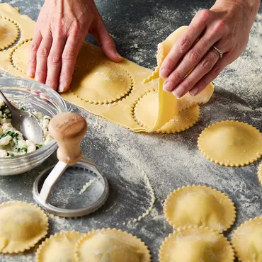 teen making filled pasta with fresh pasta dough in Sur La Table kitchen