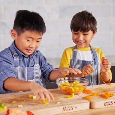 two boys chopping veggies in Sur La Table kitchen