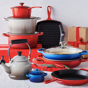 Colorful Le Creuset cookware and tea kettle