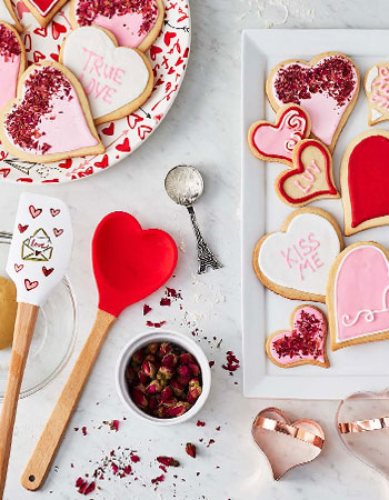 Valentine's Day heart spatulas with heart-shaped decorated sugar cookies
