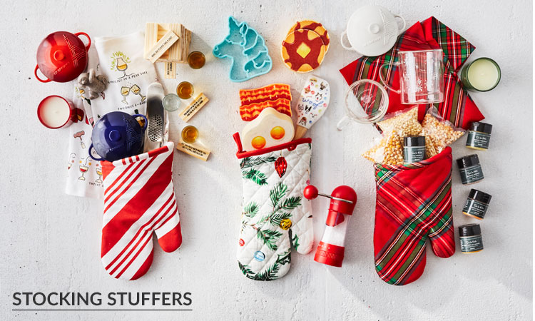 Small stocking stuffer gifts tucked inside oven mitts
