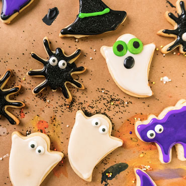 decorated Halloween sugar cookies in ghost, cat and spider shapes