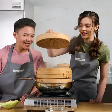 teen boy and girl steaming dumplings in Sur La Table kitchen