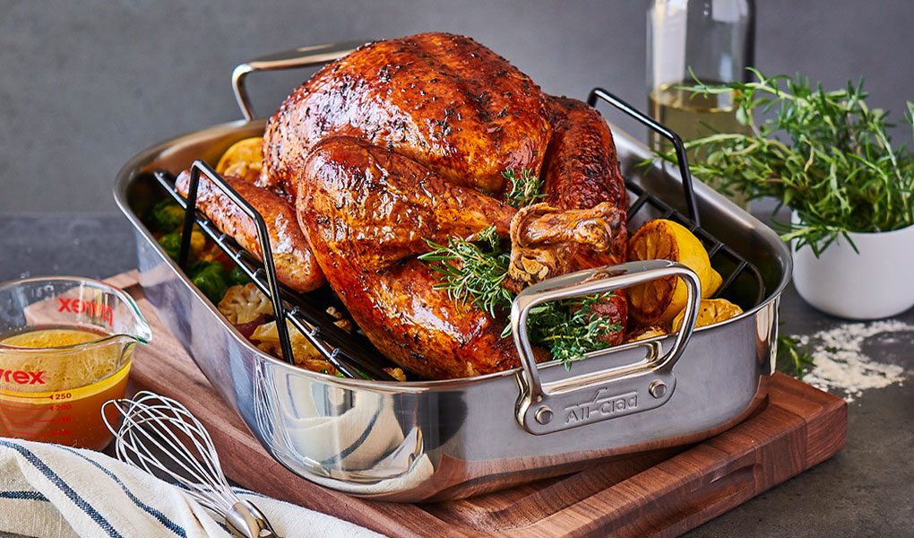 All-Clad stainless steel roasting pan with turkey