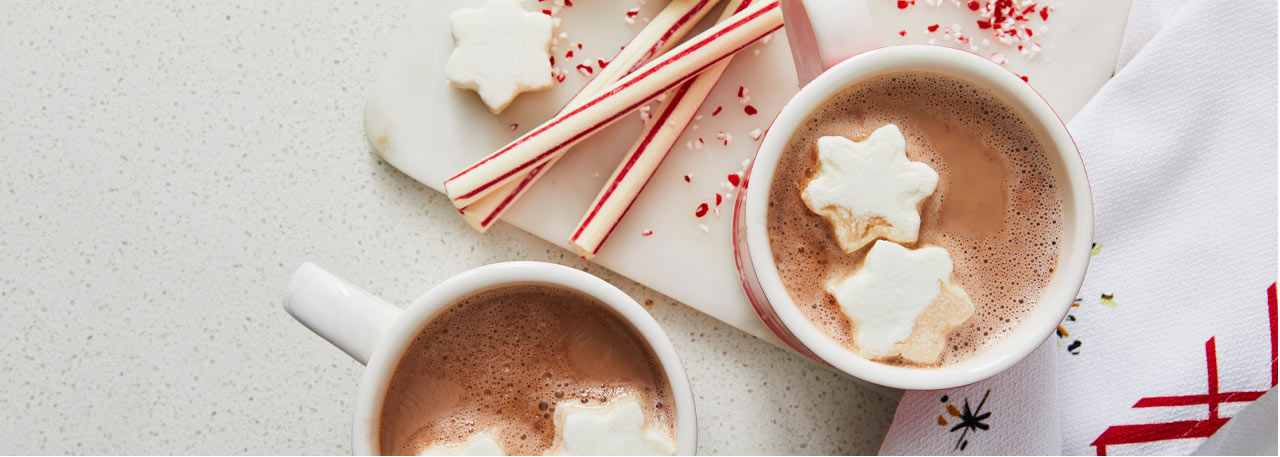Holiday hot chocolate in mugs with snowflake marshmallows