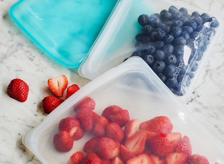 STASHER REUSABLE STORAGE BAGS filled with strawberries and blueberries