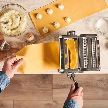 Fresh Pasta Dough sheets being formed with Atlas pasta maker