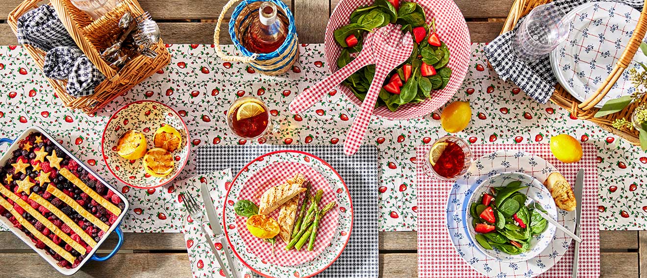 Colorful outdoor red and white dinnerware with strawberries