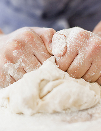 hands kneading dough