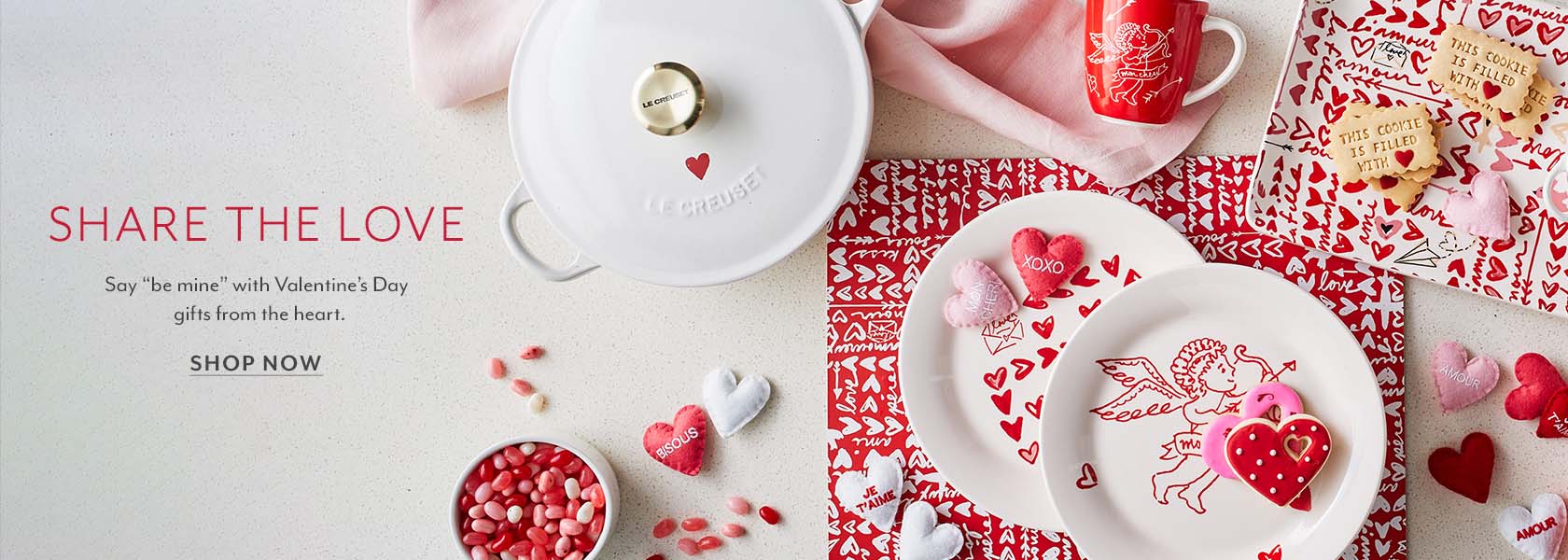 Share the love. Say Be Mine with Valentine's Day gifts from the Heart. Shop Now. White Le Creuset with red heart on lid.