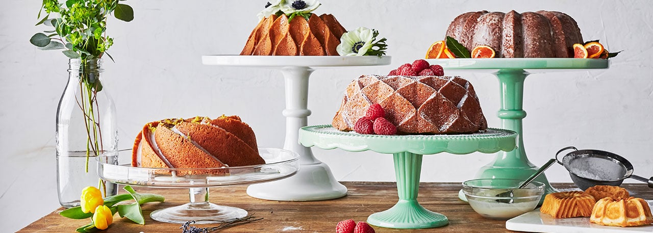 Cakes baked with Nordic Ware pans on cake stands