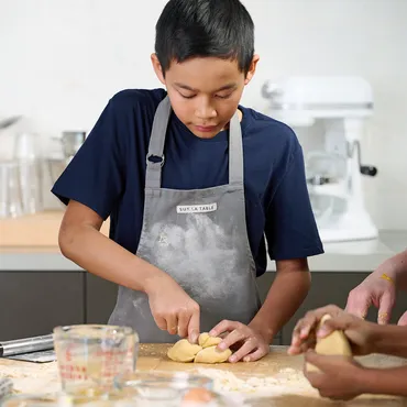 teen boy working with dough in Sur La Table kitchen