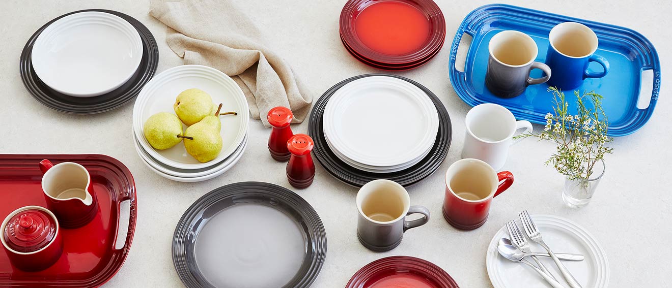 Le Creuset red, white and gray dinnerware and platter