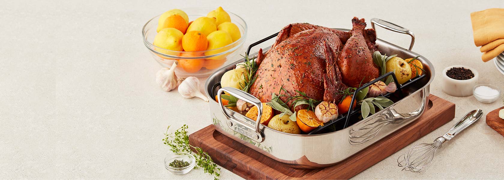 All-Clad stainless steel roasting pan with turkey