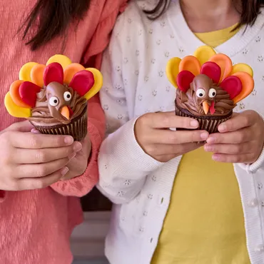 two kids holding Turkey Cupcakes