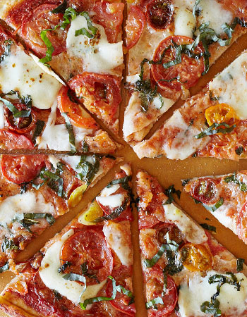 homemade pizza with tomatoes and basil