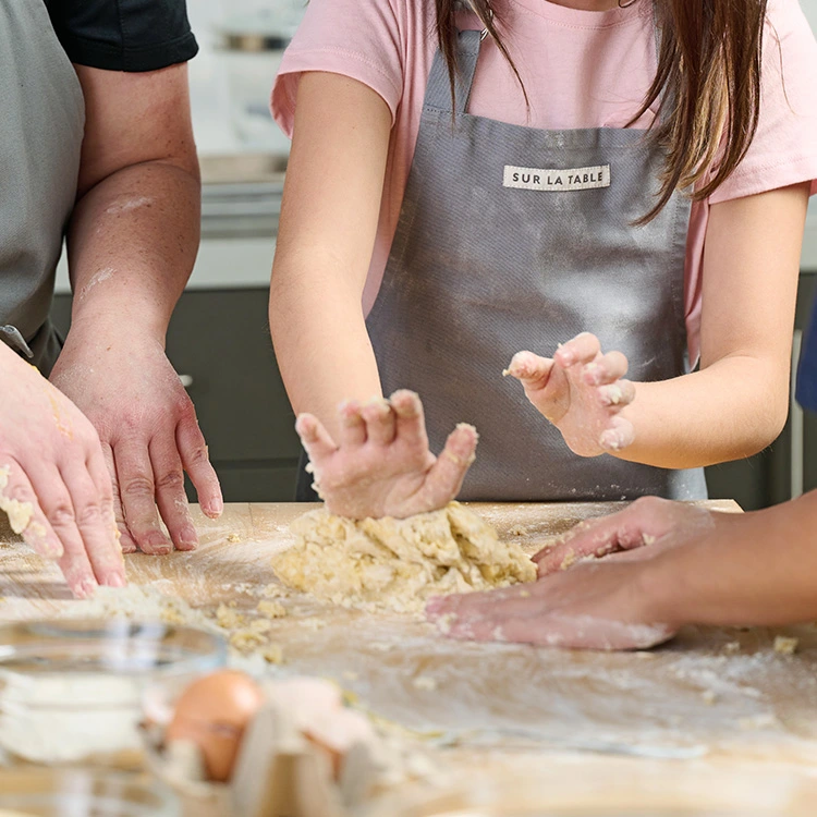 Teens kneading and making fresh pasta dough