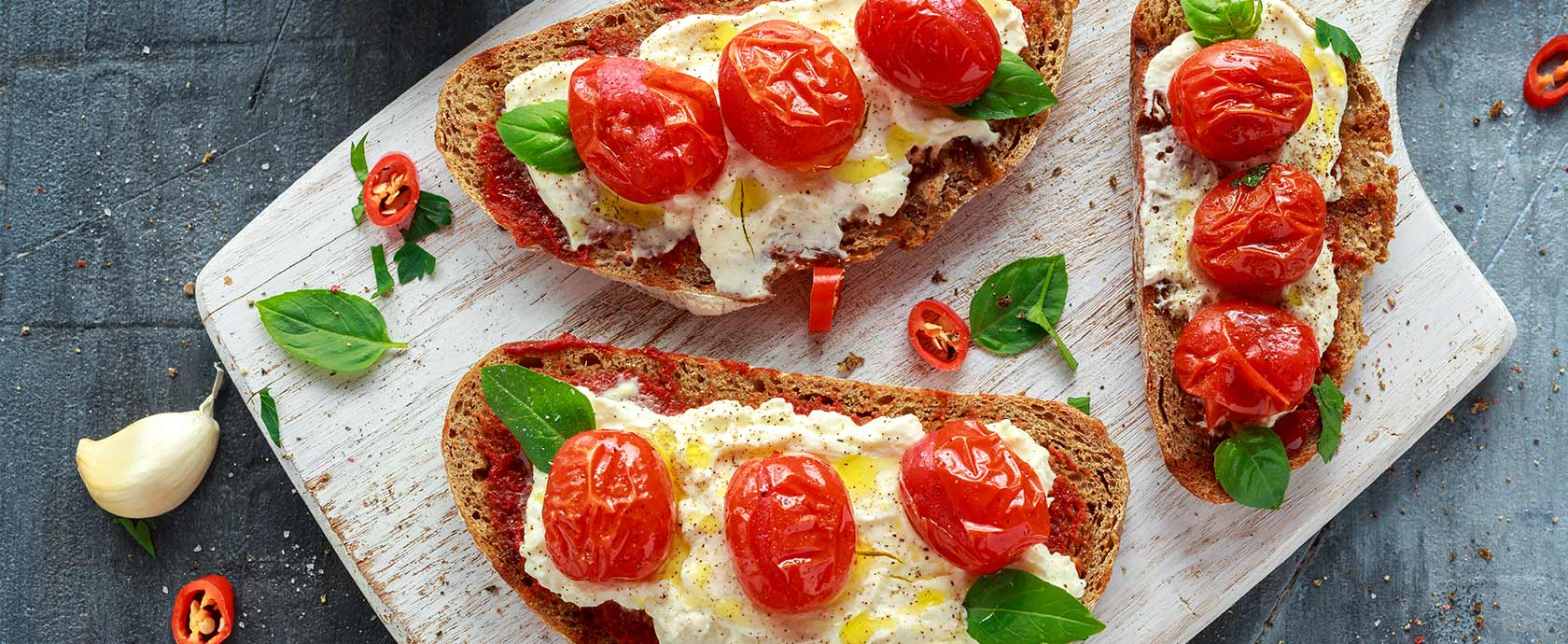 toasted bread with cheese, tomatoes and basil