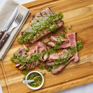 Skirt Steak with Salsa Verde on wooden board