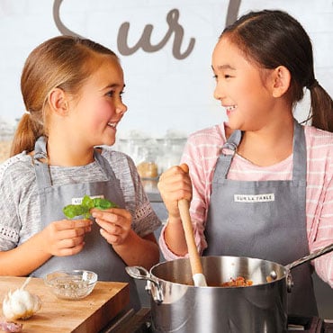 two girls cooking in kitchen