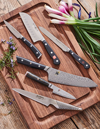 various knives on wooden cutting board