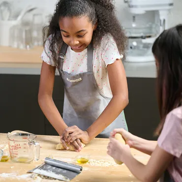 teen girl working with dough in Sur La Table kitchen