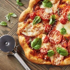 Homemade pizza with tomatoes and basil