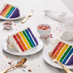 Rainbow Colored Layer Cake with white frosting