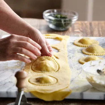 Fresh pasta dough with ravioli stamp