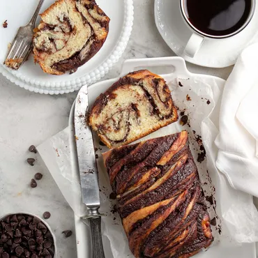Chocolate Brioche Babka loaf on white platter