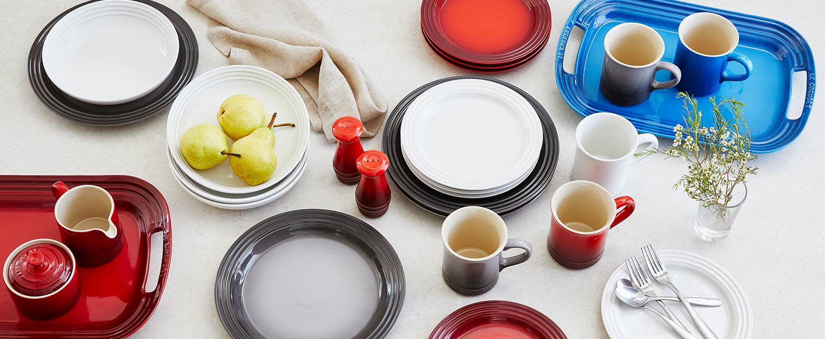 Le Creuset dinnerware in red, white, gray and blue colors