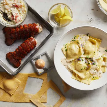 Lobster tails on sheet pan, with Lobster Ravioli with White Wine Beurre Blanc